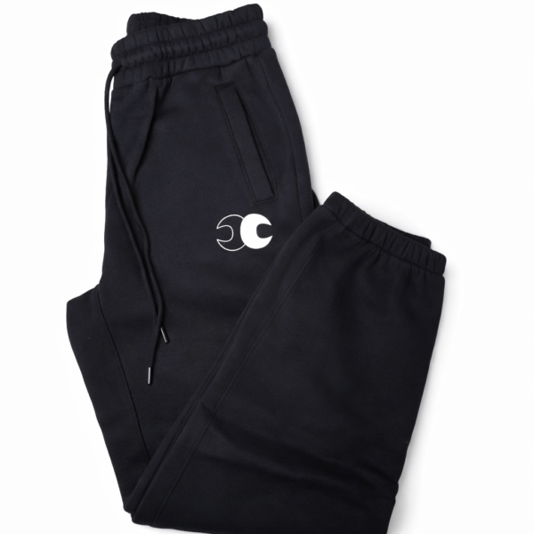 Conscious Choice Foundation Sweatpants in black featuring a relaxed oversized unisex fit, premium fleece-lined fabric, and minimalist logo detailing.